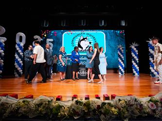 student shaking admin hands on stage