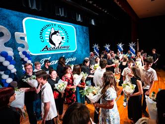 student presenting flowers