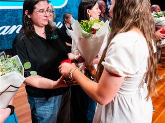 student shaking admin hands on stage
