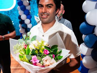 student presenting flowers