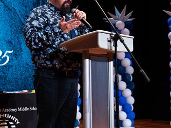 principal speaking at podium