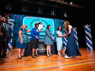 student shaking admin hands on stage
