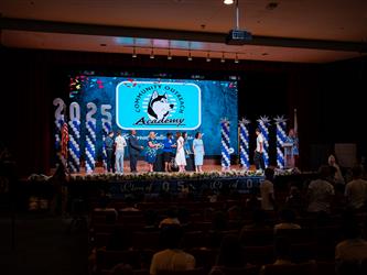 student shaking admins hands on stage