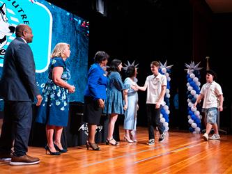 student shaking admins hands on stage