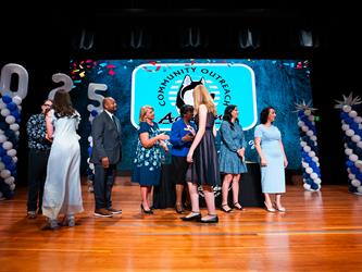 student receiving certificate on stage