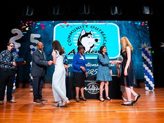 student receiving certificate on stage