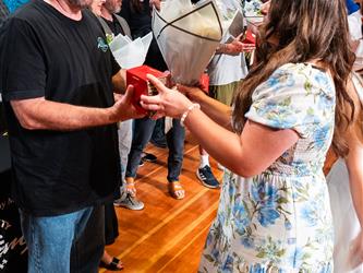 student shaking admin hands on stage