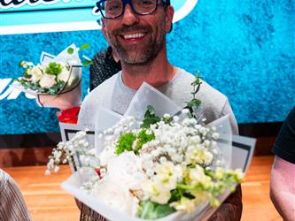student presenting flowers