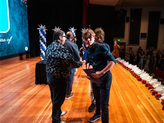 student receiving certificate on stage
