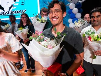 student presenting flowers