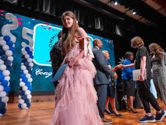 student shaking admin hands on stage