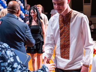 student receiving certificate on stage