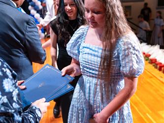 student receiving certificate on stage