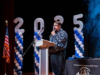 principal speaking at podium