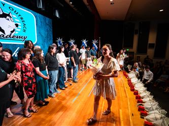 student receiving certificate on stage