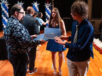 student receiving certificate on stage