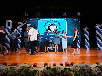 student shaking admin hands on stage
