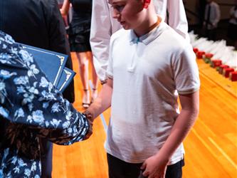 student receiving certificate on stage