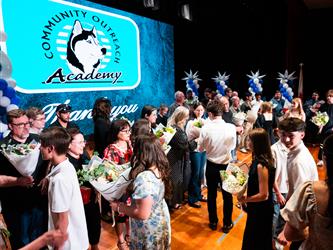 student presenting flowers