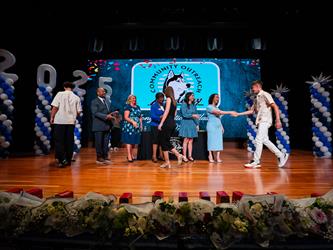 student shaking admin hands on stage