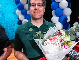 student presenting flowers