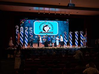 student shaking admins hands on stage