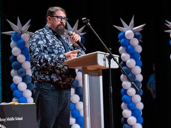 principal speaking at podium
