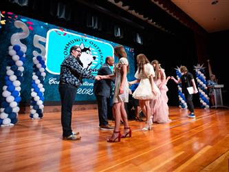 student shaking admin hands on stage
