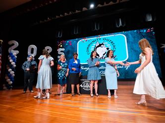 student shaking admin hands on stage