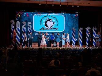 student shaking admins hands on stage