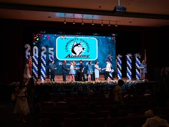 student shaking admins hands on stage