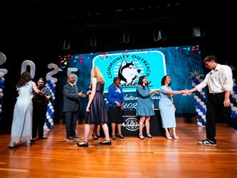 student receiving certificate on stage